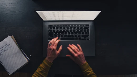 Hand writing on laptop